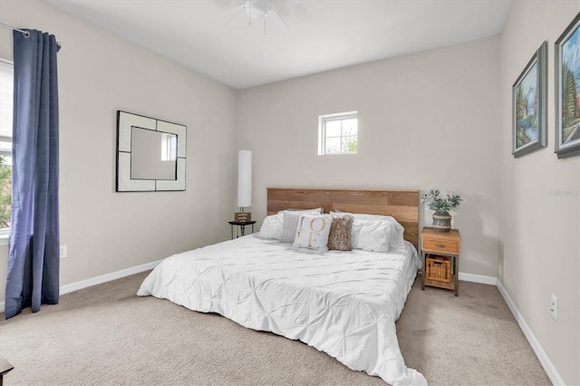 carpeted bedroom featuring baseboards and ceiling fan