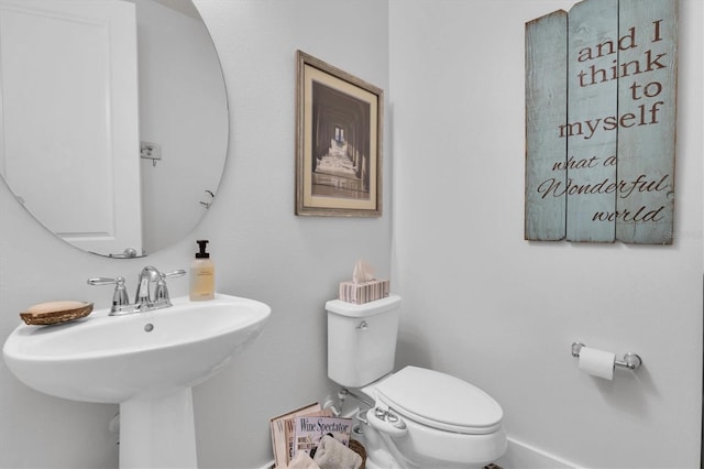bathroom featuring toilet and a sink
