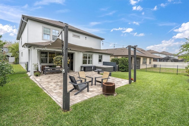 back of house with a fenced backyard, stucco siding, a patio, and a yard