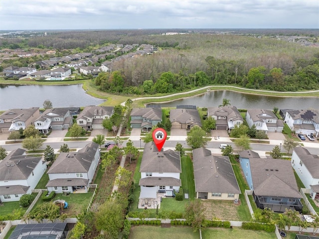 drone / aerial view featuring a water view and a residential view