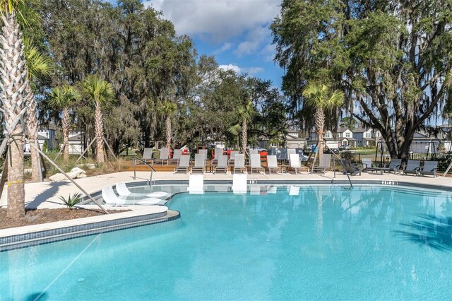 pool with fence and a patio area
