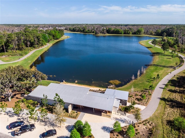 aerial view featuring a water view and a wooded view