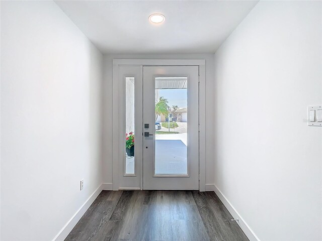 4936 Dory Dr, New Port Richey, FL 34652 - doorway to outside with baseboards and dark wood-type flooring
