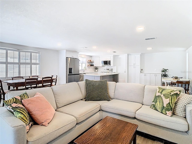 4936 Dory Dr, New Port Richey, FL 34652 - living room featuring light wood-type flooring, recessed lighting, and visible vents