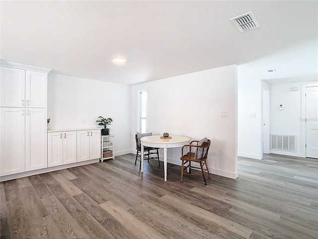 4936 Dory Dr, New Port Richey, FL 34652 - dining room featuring baseboards, visible vents, and wood finished floors