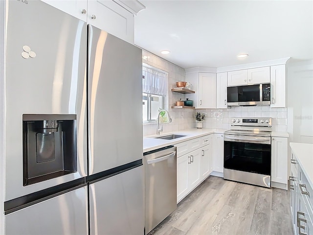 4936 Dory Dr, New Port Richey, FL 34652 - kitchen featuring light countertops, a sink, tasteful backsplash, and appliances with stainless steel finishes
