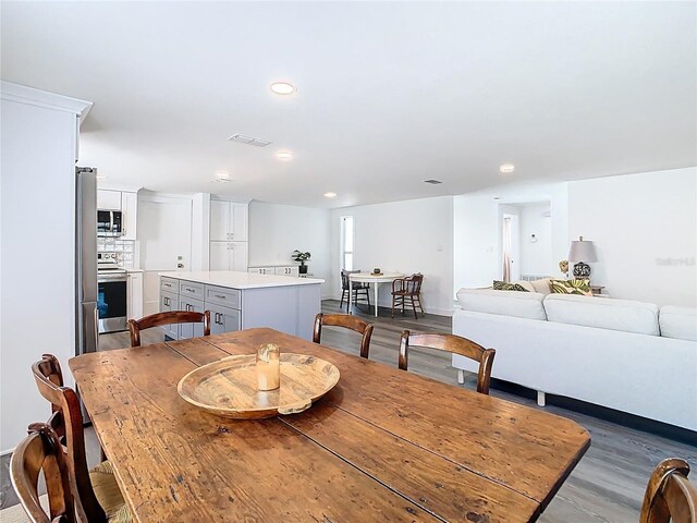 4936 Dory Dr, New Port Richey, FL 34652 - dining space featuring dark wood-type flooring, visible vents, and recessed lighting