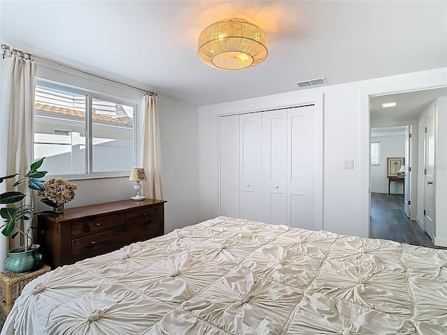 4936 Dory Dr, New Port Richey, FL 34652 - bedroom featuring a closet, visible vents, and wood finished floors