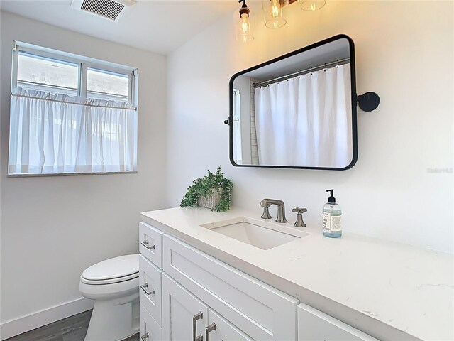 4936 Dory Dr, New Port Richey, FL 34652 - full bath with a shower with curtain, vanity, toilet, baseboards, and visible vents