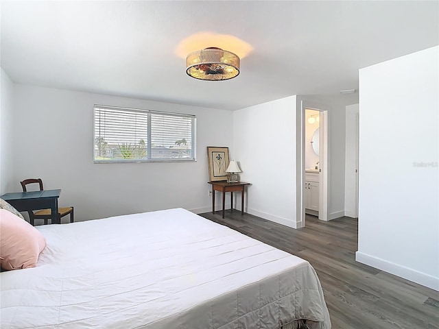 4936 Dory Dr, New Port Richey, FL 34652 - bedroom with baseboards, connected bathroom, and wood finished floors