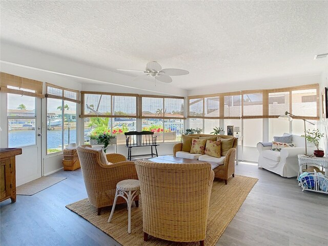 4936 Dory Dr, New Port Richey, FL 34652 - sunroom with a water view, visible vents, wood finished floors, and a textured ceiling