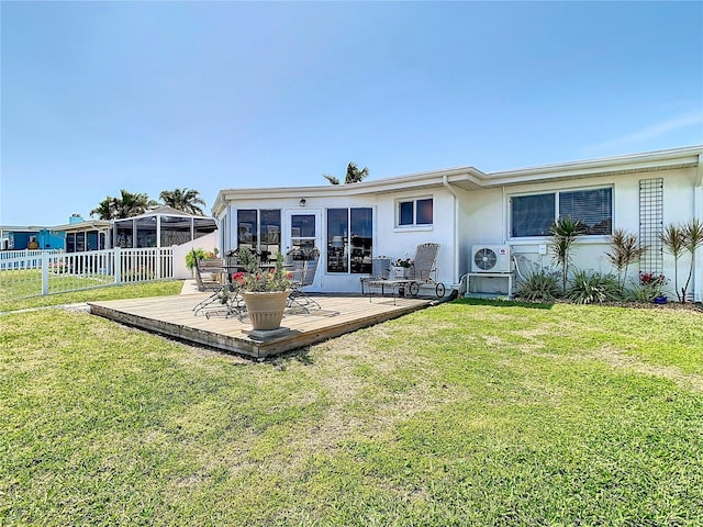 4936 Dory Dr, New Port Richey, FL 34652 - back of house with fence, a deck, ac unit, stucco siding, and a yard