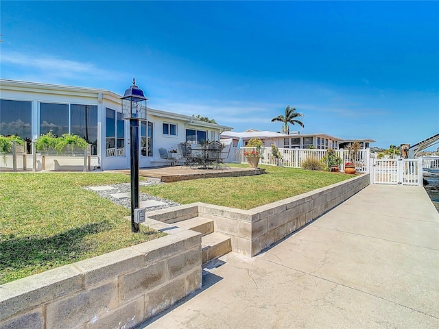 4936 Dory Dr, New Port Richey, FL 34652 - exterior space featuring a gate, fence, a front yard, and a patio area