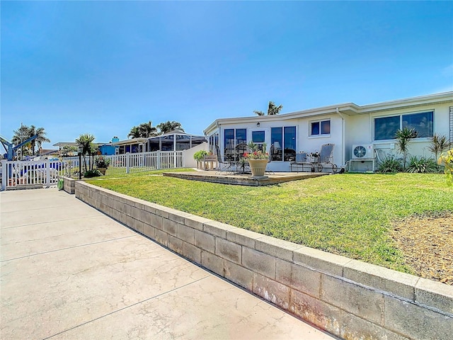 4936 Dory Dr, New Port Richey, FL 34652 - back of house featuring stucco siding, fence, a yard, and a patio area
