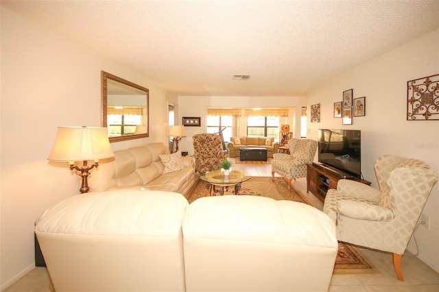 9321 Whitstone Ct, New Port Richey, FL 34655 - living area with visible vents, light tile patterned floors, and a textured ceiling