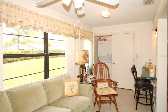 9321 Whitstone Ct, New Port Richey, FL 34655 - sitting room featuring visible vents, ceiling fan, stacked washer / drying machine, and a textured ceiling