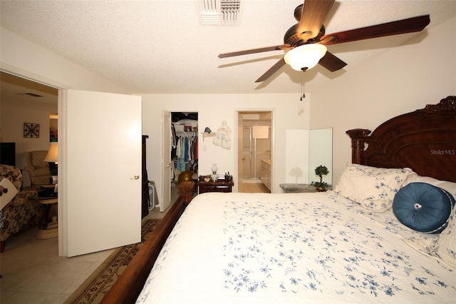 9321 Whitstone Ct, New Port Richey, FL 34655 - bedroom featuring a closet, a textured ceiling, visible vents, connected bathroom, and a ceiling fan