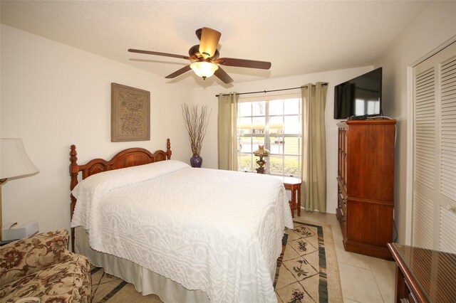 9321 Whitstone Ct, New Port Richey, FL 34655 - bedroom featuring a ceiling fan, light tile patterned flooring, and a closet