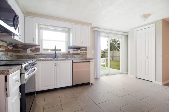 2620 Baltic Pl, Holiday, FL 34691 - kitchen featuring a sink, stainless steel microwave, white cabinetry, range with electric stovetop, and dishwasher
