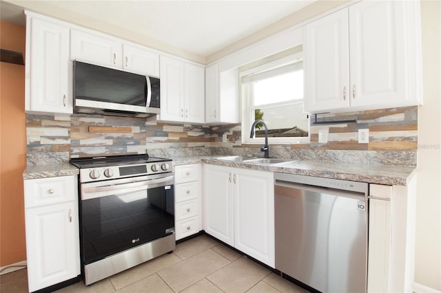 2620 Baltic Pl, Holiday, FL 34691 - kitchen featuring white cabinets, stainless steel appliances, and a sink