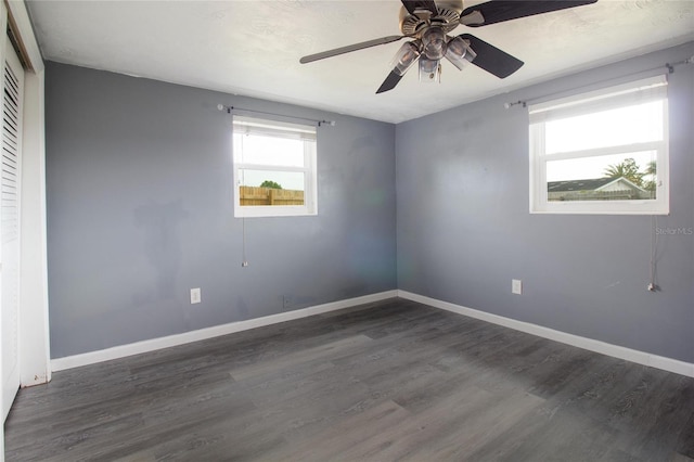 2620 Baltic Pl, Holiday, FL 34691 - spare room featuring dark wood finished floors, baseboards, and ceiling fan
