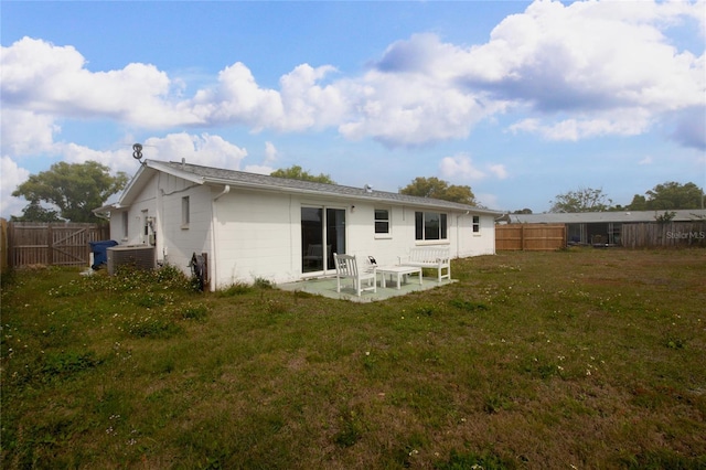 2620 Baltic Pl, Holiday, FL 34691 - rear view of property with a yard, a fenced backyard, and a patio