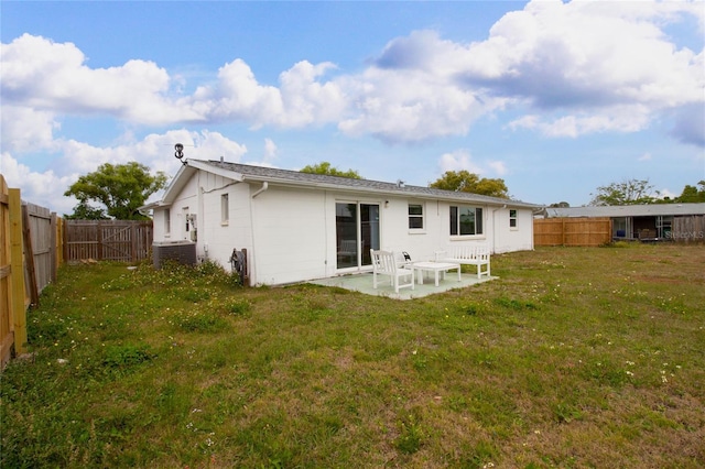 2620 Baltic Pl, Holiday, FL 34691 - rear view of property featuring a patio, a fenced backyard, a yard, and central AC unit