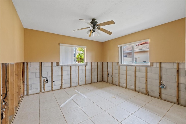 5000 Southshore Dr, New Port Richey, FL 34652 - tiled empty room with ceiling fan and wainscoting