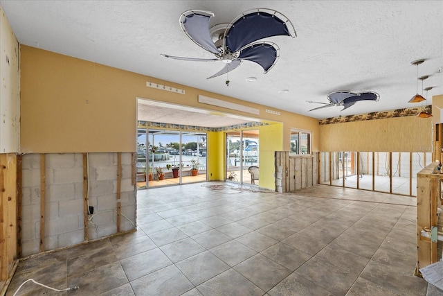 5000 Southshore Dr, New Port Richey, FL 34652 - unfurnished room featuring a ceiling fan and a textured ceiling