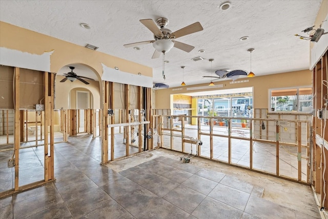 5000 Southshore Dr, New Port Richey, FL 34652 - misc room featuring ceiling fan, a textured ceiling, and arched walkways