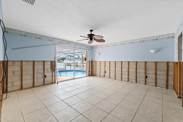 5000 Southshore Dr, New Port Richey, FL 34652 - tiled spare room with a ceiling fan