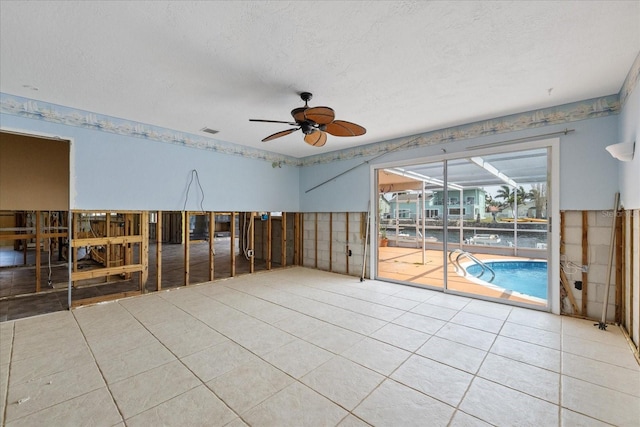 5000 Southshore Dr, New Port Richey, FL 34652 - spare room featuring a ceiling fan, tile patterned flooring, and a textured ceiling