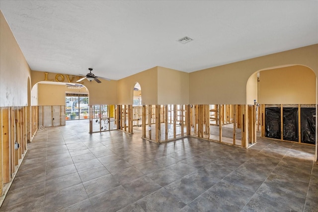 5000 Southshore Dr, New Port Richey, FL 34652 - unfurnished room with arched walkways and a ceiling fan