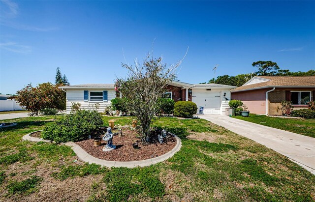 4107 Glissade Dr, New Port Richey, FL 34652 - ranch-style house featuring brick siding, a garage, a front lawn, and concrete driveway