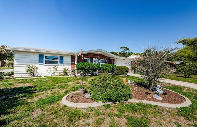 4107 Glissade Dr, New Port Richey, FL 34652 - single story home featuring brick siding, concrete driveway, and a front yard