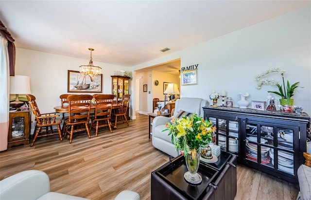4107 Glissade Dr, New Port Richey, FL 34652 - living area with light wood-type flooring, a chandelier, and visible vents