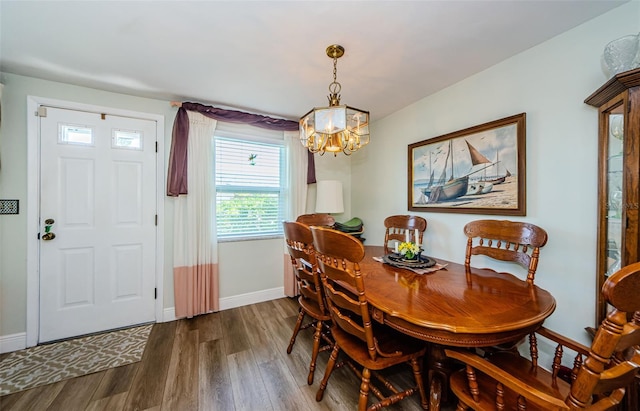 4107 Glissade Dr, New Port Richey, FL 34652 - dining room with baseboards, a notable chandelier, and dark wood-type flooring