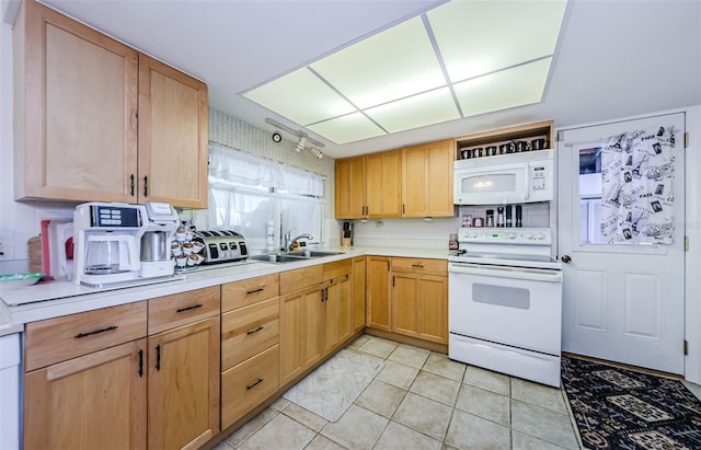 4107 Glissade Dr, New Port Richey, FL 34652 - kitchen with light tile patterned flooring, light countertops, white appliances, a sink, and light brown cabinetry