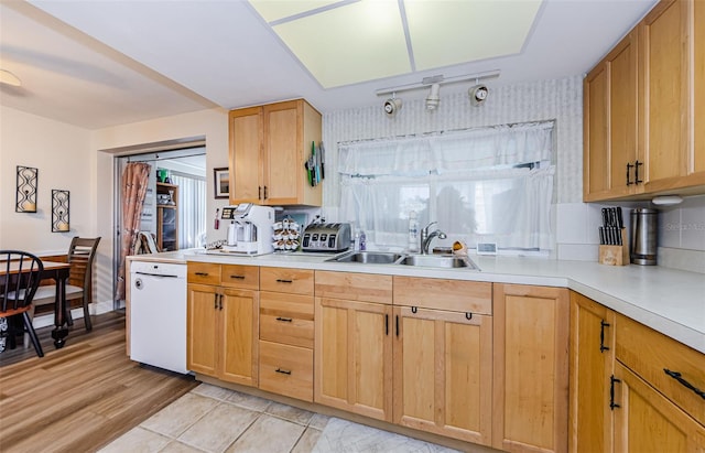 4107 Glissade Dr, New Port Richey, FL 34652 - kitchen featuring light countertops, a sink, light wood-type flooring, white dishwasher, and light brown cabinetry