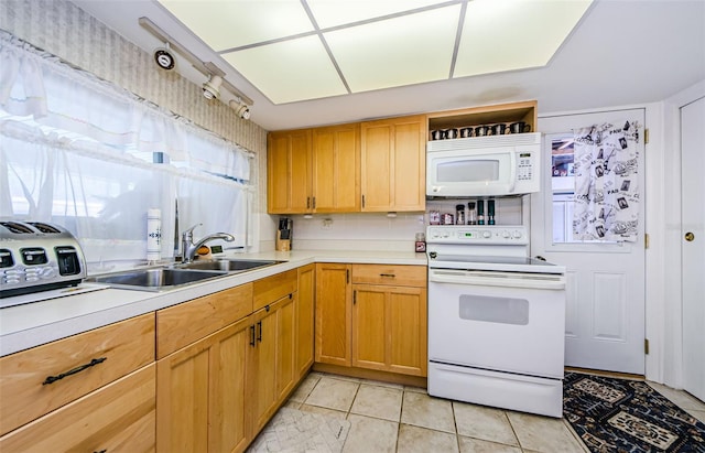 4107 Glissade Dr, New Port Richey, FL 34652 - kitchen with light countertops, a sink, light tile patterned floors, and white appliances
