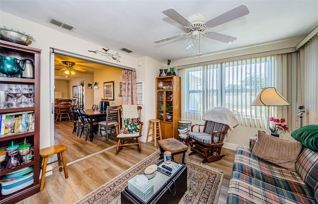 4107 Glissade Dr, New Port Richey, FL 34652 - living room featuring baseboards, visible vents, light wood-style floors, and a ceiling fan