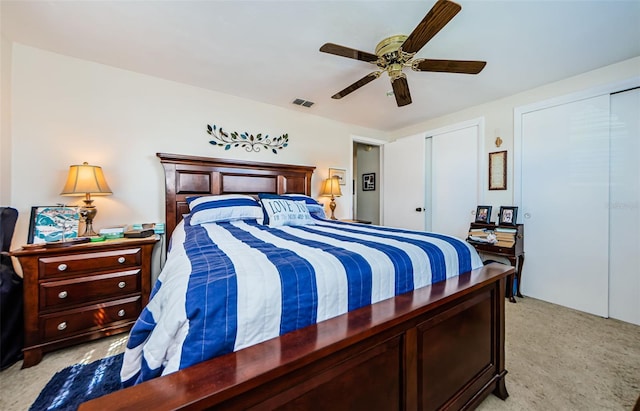 4107 Glissade Dr, New Port Richey, FL 34652 - bedroom with ceiling fan, visible vents, two closets, and light colored carpet