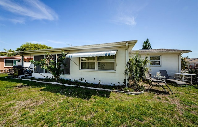 4107 Glissade Dr, New Port Richey, FL 34652 - rear view of house featuring concrete block siding and a yard