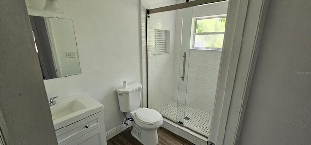 807 S Castle Ct, Tampa, FL 33612 - bathroom featuring baseboards, toilet, wood finished floors, vanity, and a stall shower