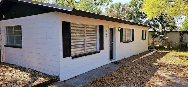 807 S Castle Ct, Tampa, FL 33612 - view of home's exterior featuring concrete block siding and fence
