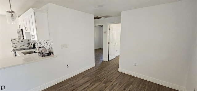 807 S Castle Ct, Tampa, FL 33612 - interior space with dark wood-style floors, baseboards, and a sink