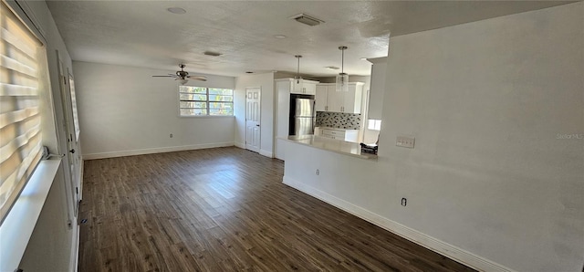807 S Castle Ct, Tampa, FL 33612 - unfurnished living room with a textured ceiling, dark wood-style floors, baseboards, visible vents, and ceiling fan
