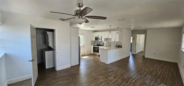 807 S Castle Ct, Tampa, FL 33612 - kitchen with white cabinetry, backsplash, appliances with stainless steel finishes, and dark wood-type flooring