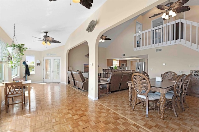 4058 Centavo Ct, Hernando Beach, FL 34607 - dining space with ceiling fan, arched walkways, stairs, baseboards, and high vaulted ceiling