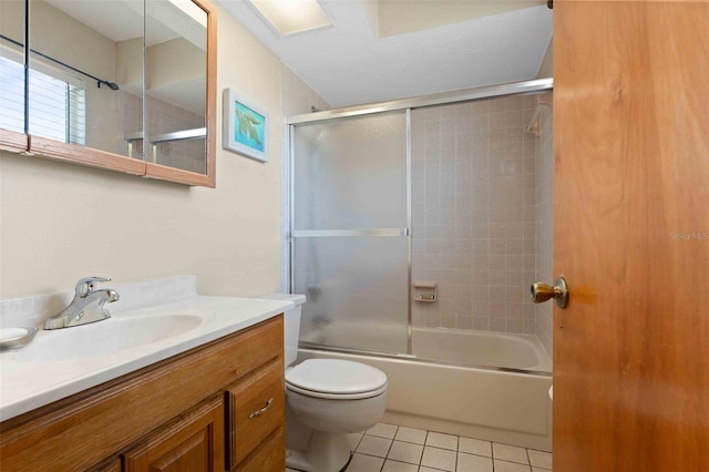 4058 Centavo Ct, Hernando Beach, FL 34607 - bathroom with tile patterned floors, vanity, toilet, and shower / bath combination with glass door